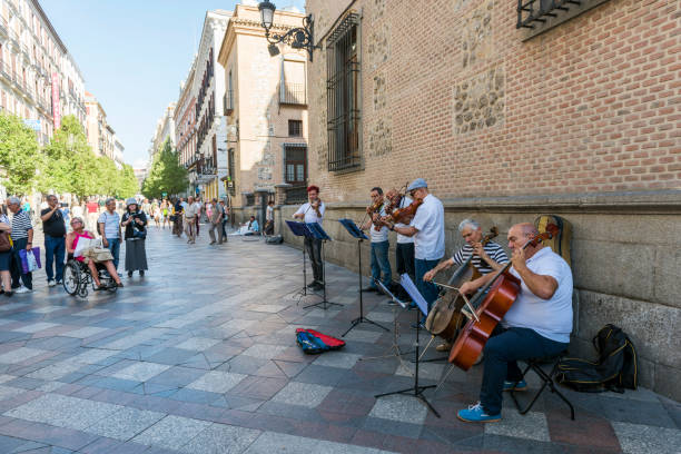 Madrid, Spain - May 25, 2017: Street musicians in Sol Palace (square) at Madrid, Spain. They are playing classic music with some instrument and earning money by using classic musical instruments (violin, cello) in street of Madrid.