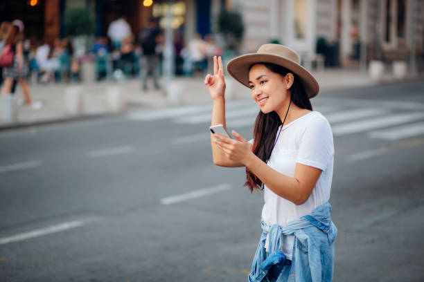 istock Cute asian woman calling for transport 1207368478