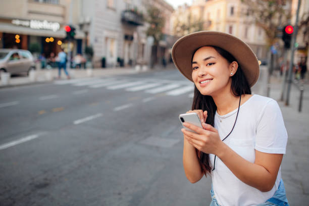 istock Cute asian woman calling for transport 1207368498