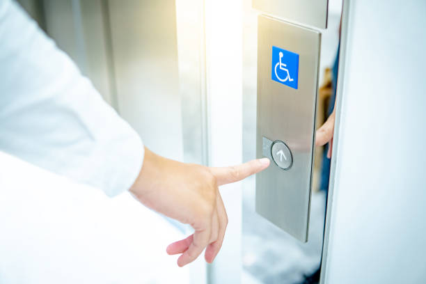 istock Male hand pressing on up button of disabled lift 1207368687