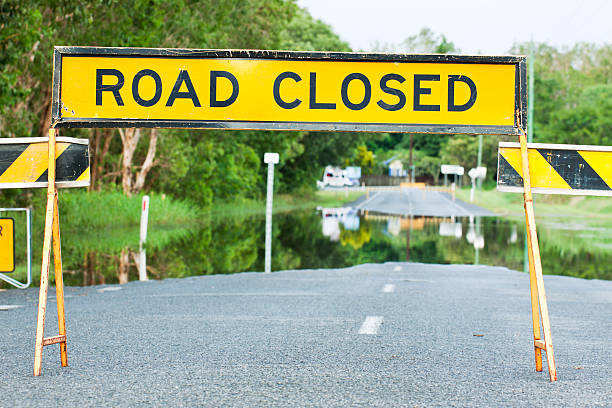 Road closed traffic sign on a flooded street A road closed sign on a flooded road in Queensland, Australia queensland floods stock pictures, royalty-free photos & images