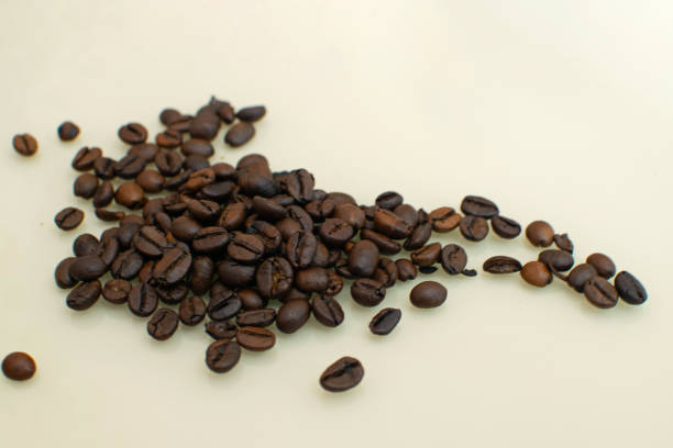 istock Brown arabica coffee beans on light background. 1207372511