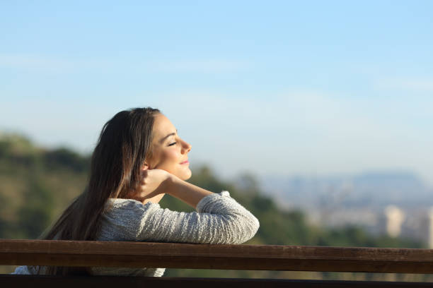 istock Woman relaxing relieving stress on a bench 1207374797