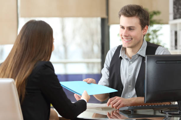 istock Businessman giving documents to a client at office 1207375689