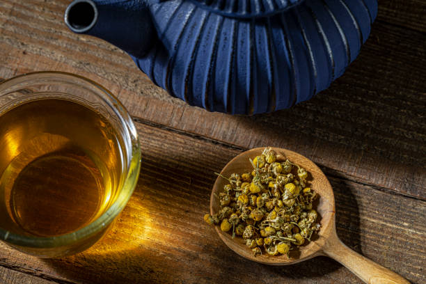 istock Chamomile herbal tea on wooden surface. 1207380496
