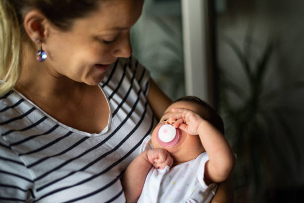 istock Mother comforts newborn baby 1207381472