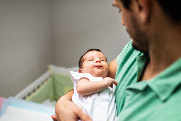 istock Father holding newborn baby 1207382103