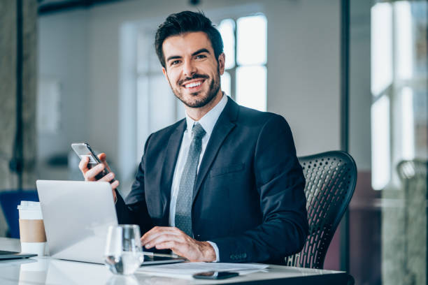 istock Handsome businessman sitting in modern office. 1207382424
