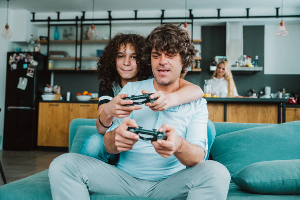 istock Father and son playing digital games at home 1207382442
