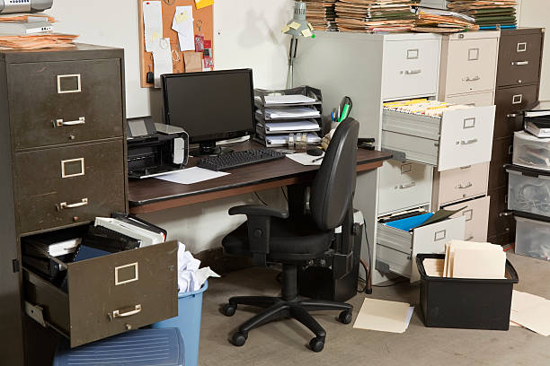Very messy office with file cabinets stock photo