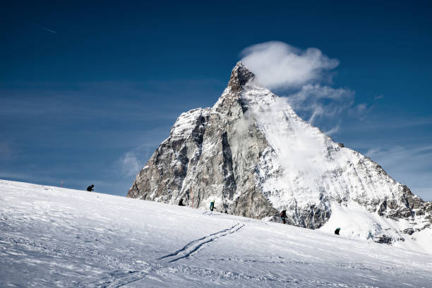 istock skiing under Matterhorn peak, Swiss Alps 1207383983