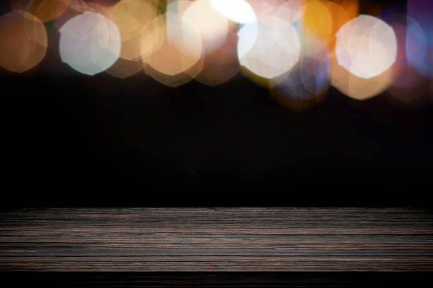 istock Empty wooden table platform and bokeh at night. 1207384035