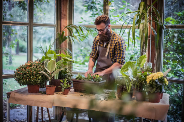 istock Gardener in a flower shop 1207384178