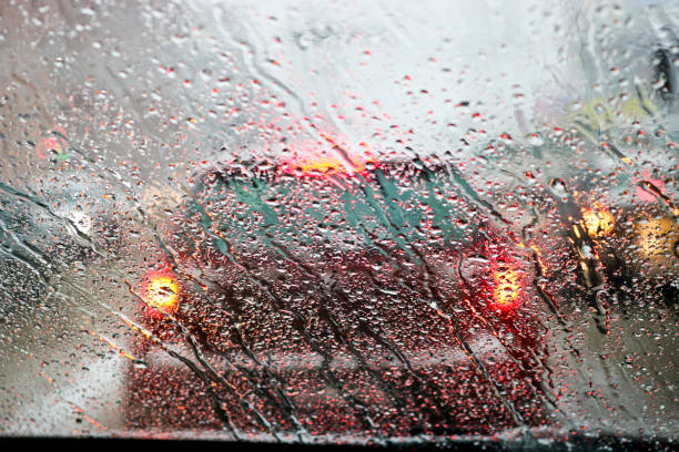 istock View from the car windscreen during rain and wet snow. Poor visibility while driving around the city. Snowy road. 1207385921