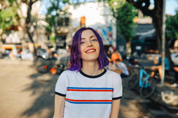 Portrait of a young woman in Palermo, Buenos Aires Young hip woman standing in the street and posing, Buenos Aires, Argentina. purple hair stock pictures, royalty-free photos & images