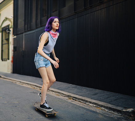 Young woman skateboarding in the street, Buenos Aires, Argentina.