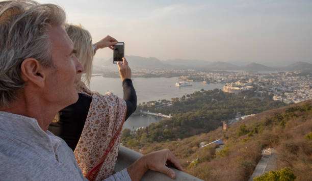 istock Mature couple look off to view from hillside 1207401171