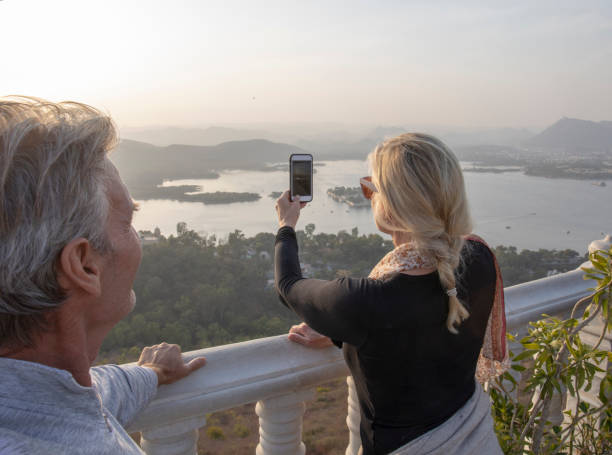 istock Mature couple look off to view from hillside 1207401182
