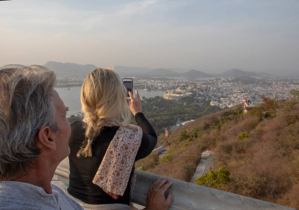 istock Mature couple look off to view from hillside 1207401193