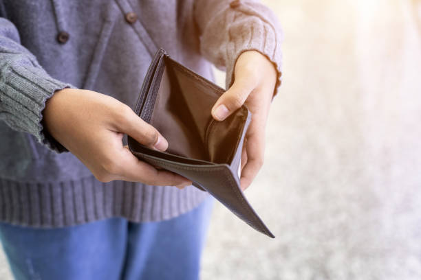 istock Asian young  tourist counting or checking banknote in black wallet 1207404181