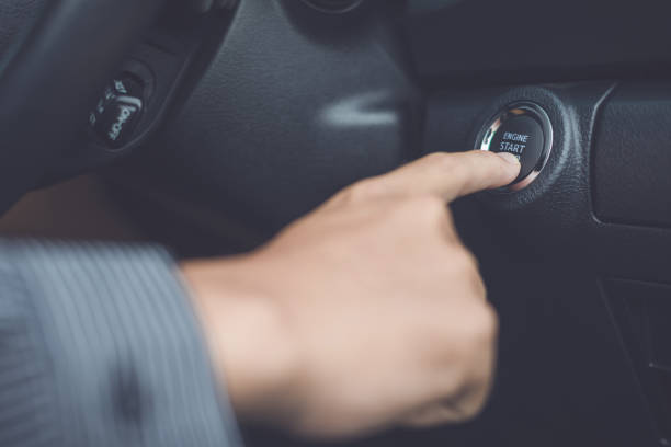 istock Hand of man pressing button start/stop car engine inside the modern car 1207404280