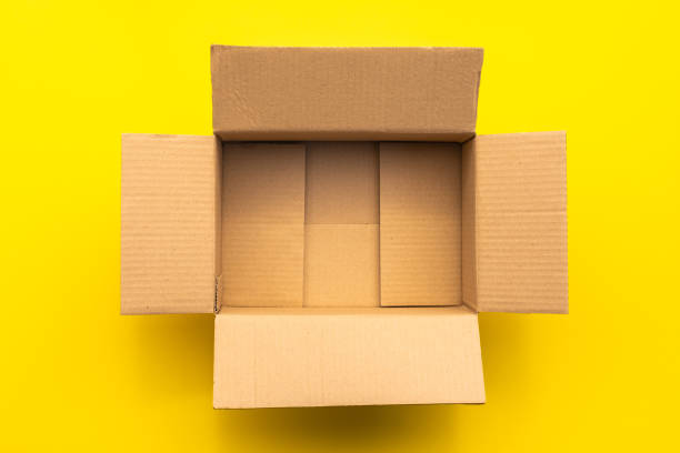 istock Top view empty brown post or carton box on yellow paper background 1207413471