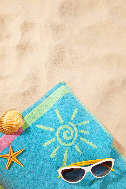 istock towel and sunglasses on beach 120741382