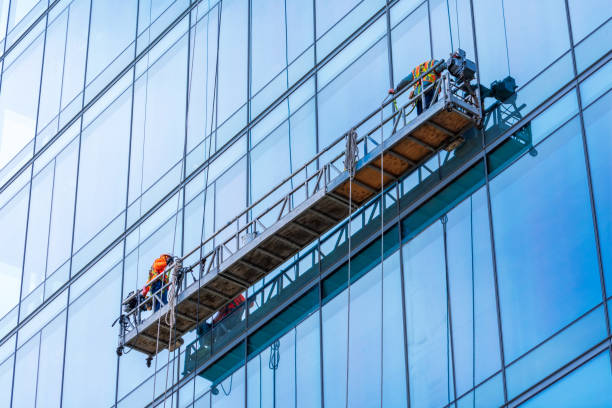 istock Professional high rise window cleaning service workers in gondola. Two workers use specialized equipment to access and clean glass windows of skyscraper as preventative maintenance and repair measure 1207416887