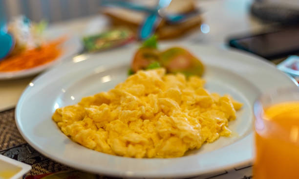 istock Scrambled egg presented on a white plate at breakfast table. Healthy Breakfast Concept. 1207419891