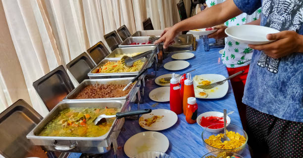 istock Buffet breakfast at a restaurant. People serving breakfast delicacies. 1207419979
