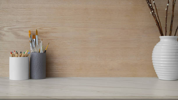 istock Close up view of workplace with copy space, painting tools and ceramic vase 1207432886