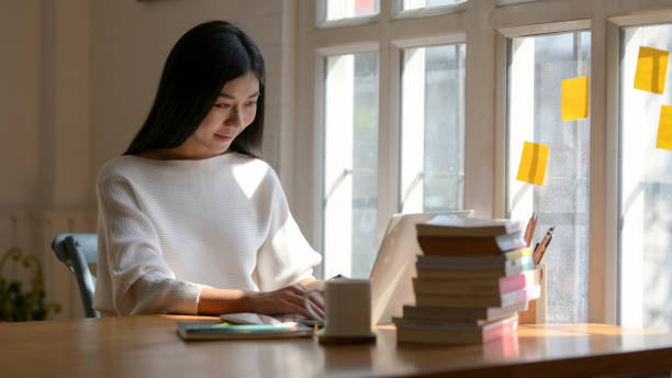 istock Close up view of college girl typing on laptop while working on her project 1207433009