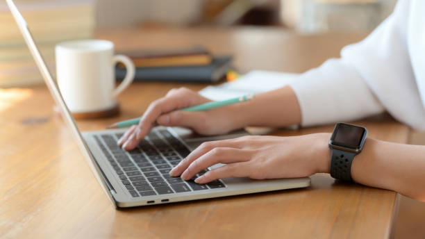 istock Side view of college girl typing on laptop while working on her project 1207433029