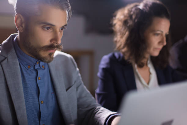 istock Concentrated handsome businessman looking at laptop 1207434548