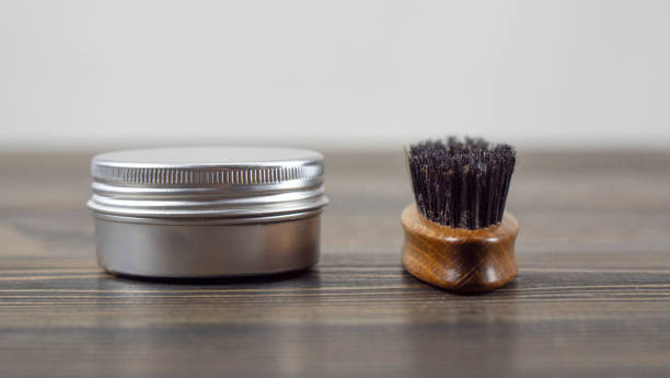 Beard Brush And Wax Jar for Beard And Mustache On A Wooden Table. Barber Accessories. High Quality Photo Beard Brush And Wax Jar for Beard And Mustache On A Wooden Table. Barber Accessories. High Quality Photo Combing stock pictures, royalty-free photos & images