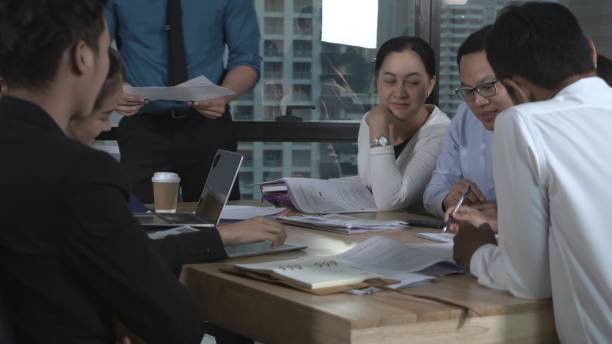 istock Asian business people discuss marketing strategy. 1207437011