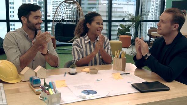 istock Creative business people group having conversation at office desk in workplace. 1207437043