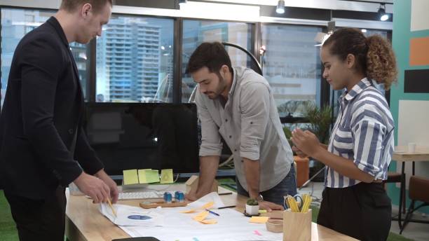 istock Creative business people group having conversation at office desk in workplace. 1207437112