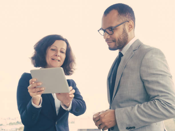 istock Satisfied business leaders watching project presentation 1207439368