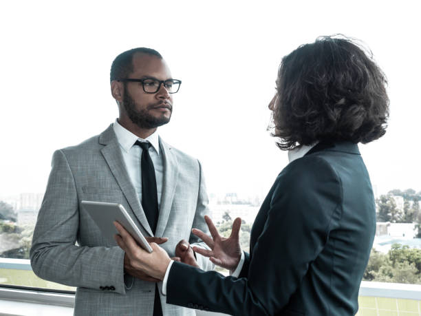 istock Serious business partners discussing deal 1207440539