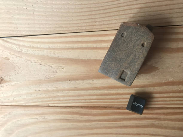 istock side shot of the brown ceramic house and a home black button from computer keyboard 1207441503