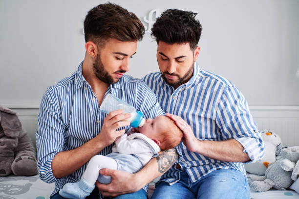 a gay couple with their son - gay parents concept a young gay couple with their son - gay parents concept artificial insemination photos stock pictures, royalty-free photos & images