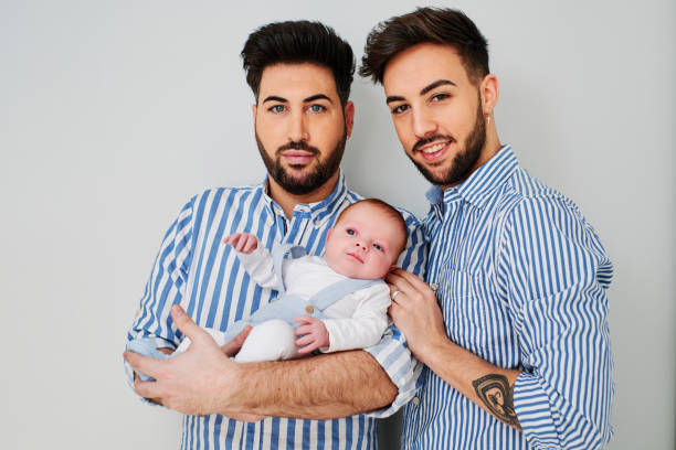 a gay couple with their son - gay parents concept a young gay couple with their son - gay parents concept gay daddy stock pictures, royalty-free photos & images