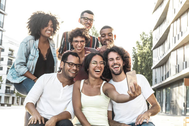 istock Happy excited Latin woman taking group selfie 1207446687