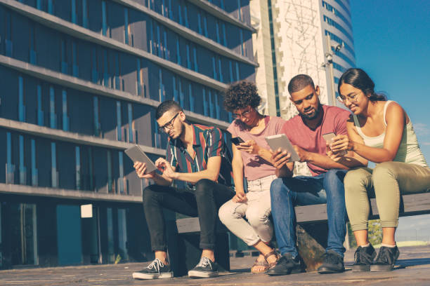 istock Happy young men and women watching and discussing content 1207446942