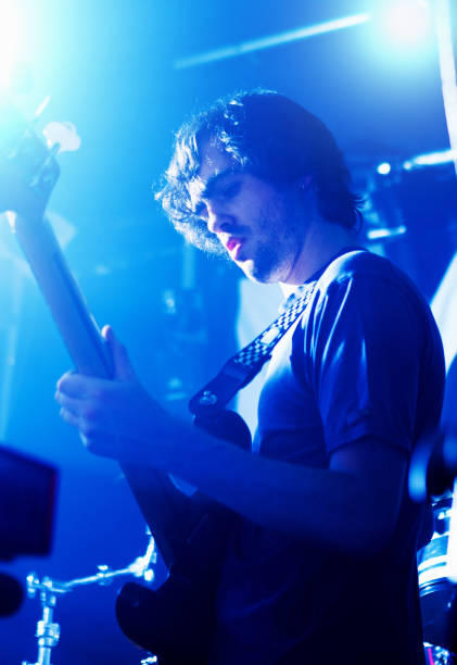 istock Young rock god guitarist performing on stage 1207447886