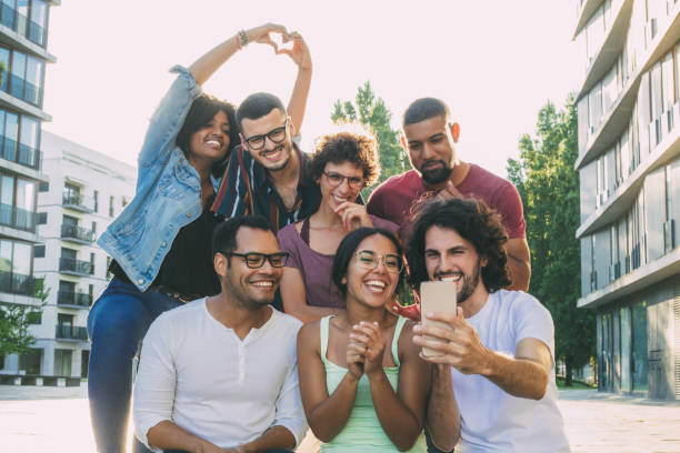 istock Excited overjoyed multiethnic people taking group selfie 1207448700