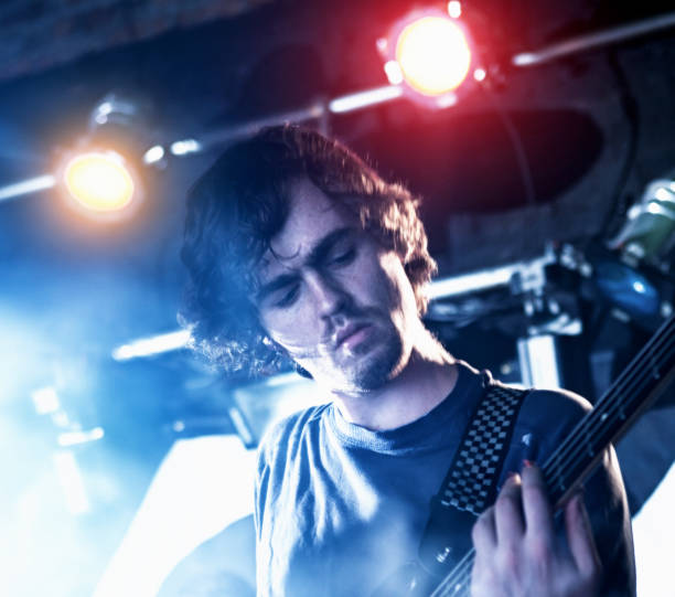 istock Handsome young rock guitarist playing in concert 1207449530
