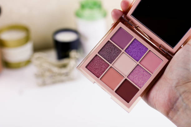istock Makeup eyeshadow palette in female hand on the white background. 1207451104