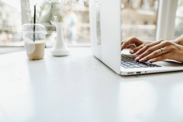 istock Hands typing on laptop keyabord on white table at office 1207451548